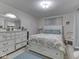 Bedroom featuring neutral walls, patterned bedding, and a matching dresser at 5457 Happy Hollow, Indianapolis, IN 46268