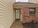 Close-up of the front door with sidelight and brick accents at 5457 Happy Hollow, Indianapolis, IN 46268