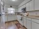 Functional kitchen featuring white cabinets and wood-look flooring at 5457 Happy Hollow, Indianapolis, IN 46268