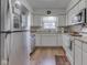 Kitchen with white cabinets, updated appliances, and a cozy window view at 5457 Happy Hollow, Indianapolis, IN 46268