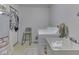 Functional laundry room with a washer, utility sink, storage, and a chair for convenience at 5457 Happy Hollow, Indianapolis, IN 46268
