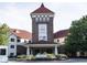 Elegant main entrance showcasing the building's clock tower and well-maintained landscaping at 5457 Happy Hollow, Indianapolis, IN 46268