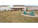 Spacious backyard featuring a covered patio with a built-in grill and a charming fire pit area at 5630 N Rockingham Ln, McCordsville, IN 46055