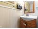 Bathroom with a cream and wood vanity, mirror and wall art at 5630 N Rockingham Ln, McCordsville, IN 46055