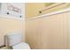 Bathroom with wainscoting, corner shelving and a white toilet at 5630 N Rockingham Ln, McCordsville, IN 46055