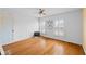 Bright bedroom featuring hardwood floors, white walls, windows with shutters, and a stylish ceiling fan at 5630 N Rockingham Ln, McCordsville, IN 46055