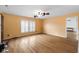 Bedroom with wood floors, orange walls, a ceiling fan, and shuttered windows at 5630 N Rockingham Ln, McCordsville, IN 46055