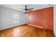 Bedroom with hardwood floors, a ceiling fan, and a window with white shutters at 5630 N Rockingham Ln, McCordsville, IN 46055