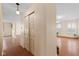 Hallway with closet and entrance to spacious living room with hardwood floors and neutral colors at 5630 N Rockingham Ln, McCordsville, IN 46055