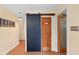Hallway featuring barn door, wood flooring, and neutral-toned walls at 5630 N Rockingham Ln, McCordsville, IN 46055