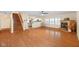 Open-concept living room with a staircase and a fireplace, featuring hardwood floors at 5630 N Rockingham Ln, McCordsville, IN 46055