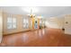 Spacious living room with hardwood floors, large windows and light color walls and trim at 5630 N Rockingham Ln, McCordsville, IN 46055