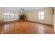 Spacious living room with hardwood floors, fireplace, and plantation shutters at 5630 N Rockingham Ln, McCordsville, IN 46055