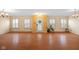 Spacious living room with hardwood floors, large windows and light color walls and trim at 5630 N Rockingham Ln, McCordsville, IN 46055