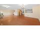Spacious living room with hardwood floors, large windows and adjacent staircase and kitchen at 5630 N Rockingham Ln, McCordsville, IN 46055