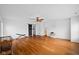 Spacious living room with hardwood floors, white walls, and modern ceiling fans at 5630 N Rockingham Ln, McCordsville, IN 46055