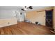 Living room featuring hardwood floors, yellow walls, and a dark barn door at 5630 N Rockingham Ln, McCordsville, IN 46055