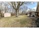 Spacious backyard featuring a storage shed, mature trees, and a screened-in porch for outdoor enjoyment at 5924 Elaine St, Indianapolis, IN 46224