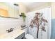Cozy bathroom with a single sink vanity, patterned shower curtain, and decorative wall art at 5924 Elaine St, Indianapolis, IN 46224
