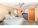 Comfortable bedroom featuring a large bed, carpet, and a view into the walk-in closet at 5924 Elaine St, Indianapolis, IN 46224