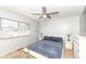 Bedroom featuring a bed, ceiling fan, bedside lamps, and natural light from a window at 5924 Elaine St, Indianapolis, IN 46224