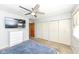 Bright bedroom with a ceiling fan, television, closet and a large bed at 5924 Elaine St, Indianapolis, IN 46224