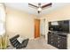 Bedroom featuring a ceiling fan, television, lounge chair, and dresser at 5924 Elaine St, Indianapolis, IN 46224