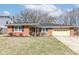 Charming one-story brick home with a covered front porch and attached garage at 5924 Elaine St, Indianapolis, IN 46224