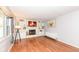 Bright living room featuring a fireplace, built-in shelving, and wood-look floors at 5924 Elaine St, Indianapolis, IN 46224