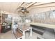 Covered patio with dining table, bench seating, and outdoor wicker furniture at 5924 Elaine St, Indianapolis, IN 46224