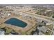 A high aerial view showcasing a neighborhood pond and surrounding residences, a peaceful community setting at 5955 Stroup Dr, Noblesville, IN 46062