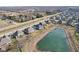 Aerial view featuring a home with a picturesque pond, surrounded by a community and greenery at 5955 Stroup Dr, Noblesville, IN 46062