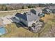 Aerial view showcases the home's backyard patio, screened in porch, and well-maintained lawn at 5955 Stroup Dr, Noblesville, IN 46062