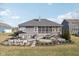 The backyard features a patio with seating, and a screened-in porch, perfect for outdoor entertaining at 5955 Stroup Dr, Noblesville, IN 46062