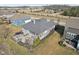 Aerial view of the backyard with a stone patio with seating and outdoor kitchen at 5955 Stroup Dr, Noblesville, IN 46062