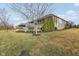 Exterior view featuring a screened porch, outdoor patio with a fire pit, and lush landscaping in a backyard setting at 5955 Stroup Dr, Noblesville, IN 46062