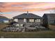 An aerial view of a large backyard with a screened porch and a stone patio with built-in grill at 5955 Stroup Dr, Noblesville, IN 46062