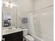 Bright bathroom with shower/tub, dark vanity, and mirror. Bedroom visible in the background at 5955 Stroup Dr, Noblesville, IN 46062