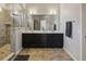 Bright bathroom showcasing a walk-in shower, double vanity, modern lighting fixtures, and neutral tile at 5955 Stroup Dr, Noblesville, IN 46062