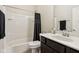 Well-lit bathroom featuring a shower-tub combo, dark wood vanity and white tile at 5955 Stroup Dr, Noblesville, IN 46062