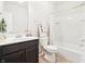 Well-lit bathroom featuring a combined shower and tub, dark vanity, and mirror at 5955 Stroup Dr, Noblesville, IN 46062