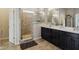 Nicely designed bathroom featuring a walk-in shower, double vanity, and dark wood cabinets at 5955 Stroup Dr, Noblesville, IN 46062