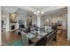 Open-concept view of the dining room with fireplace, TV, and modern kitchen at 5955 Stroup Dr, Noblesville, IN 46062