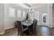 Bright dining area with modern chandelier, plantation shutters, and access to the backyard at 5955 Stroup Dr, Noblesville, IN 46062