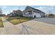 A concrete driveway leads to a two-car garage on this property with well-maintained landscaping at 5955 Stroup Dr, Noblesville, IN 46062