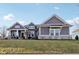 Charming gray home featuring stone accents, manicured lawn and inviting covered porch, perfect for suburban living at 5955 Stroup Dr, Noblesville, IN 46062
