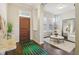 Elegant foyer with dark wood floors, patterned rug, and views into the living room creates a grand entry at 5955 Stroup Dr, Noblesville, IN 46062