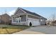 Spacious attached two car garage with white doors and gray siding offers convenient parking and storage at 5955 Stroup Dr, Noblesville, IN 46062
