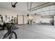 Large garage with epoxy floors, built-in storage, and plenty of room for vehicles and recreational equipment at 5955 Stroup Dr, Noblesville, IN 46062