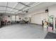 Spacious three-car garage with ample storage cabinets and room for multiple vehicles and outdoor equipment at 5955 Stroup Dr, Noblesville, IN 46062
